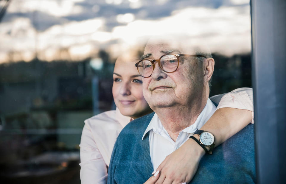 woman embracing senior man