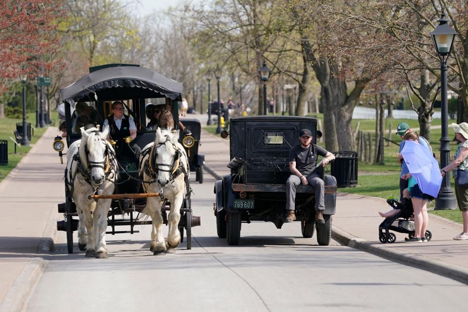 A horse-drawn bus and Model T truck pass each other at The Henry Ford, Friday, April 14, 2023, in Dearborn, Mich. Named after Ford Motor Co. founder and American industrialist Henry Ford, The Henry Ford sits on 250 acres and features a museum and Greenfield Village, where more than 80 historic structures are displayed and maintained. The Jackson House from Selma, Ala., will join the courthouse where Abraham Lincoln first practiced law, the laboratory where Thomas Edison perfected the lightbulb and the home and workshop where Orville and Wilbur Wright invented their first airplane.