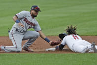Cleveland Indians' Jose Ramirez slides safely into second base on a steal as Minnesota Twins' Luis Arraez is late on the tag during the first inning in a baseball game Tuesday, Aug. 25, 2020, in Cleveland. (AP Photo/Tony Dejak)