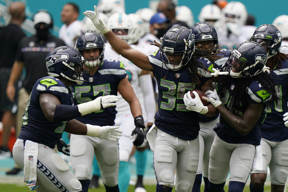 Seattle Seahawks cornerback Ryan Neal (35) is celebrated by his teammates after intercepting a pass, during the first half of an NFL football game against the Miami Dolphins, Sunday, Oct. 4, 2020 in Miami Gardens, Fla. (AP Photo/Wilfredo Lee)