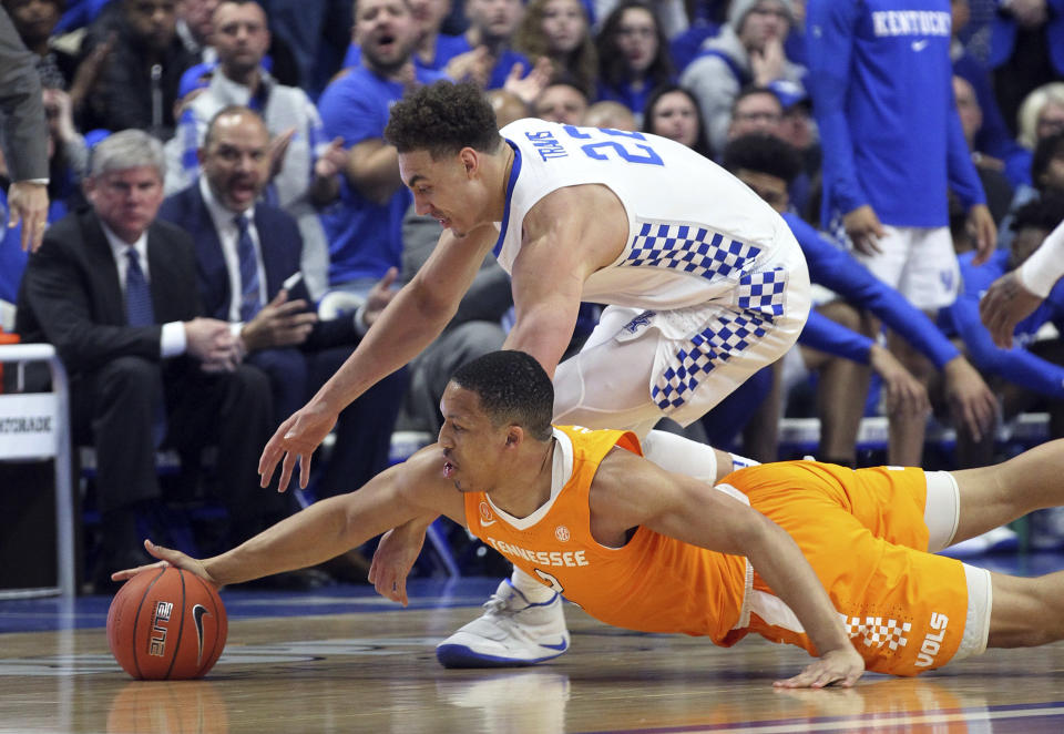 Kentucky's Reid Travis, top, and Tennessee's Grant Williams chase down a loose ball during the first half of an NCAA college basketball game in Lexington, Ky., Saturday, Feb. 16, 2019. (AP Photo/James Crisp)