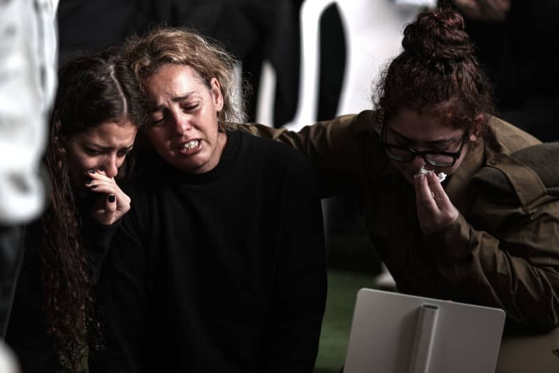 Israelis mourn during the funeral of Israeli soldier Major Ilay Levy who was killed when two buildings collapsed after Palestinians fired anti-tank missiles at the troops. There were 21 soldiers killed in the incident, according to Israeli media. Ilia Yefimovich/dpa