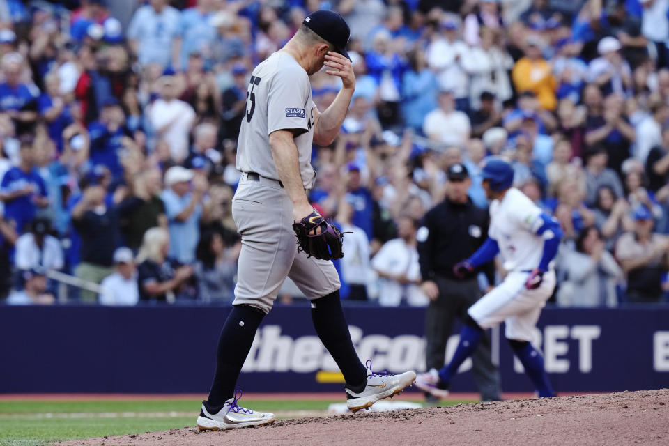 New York Yankees pitcher Carlos Rodon (55) waits as Toronto Blue Jays' George Springer runs the bases on a three-run home run during the second inning of a baseball game Thursday, June 27, 2024, in Toronto. (Frank Gunn/The Canadian Press via AP)