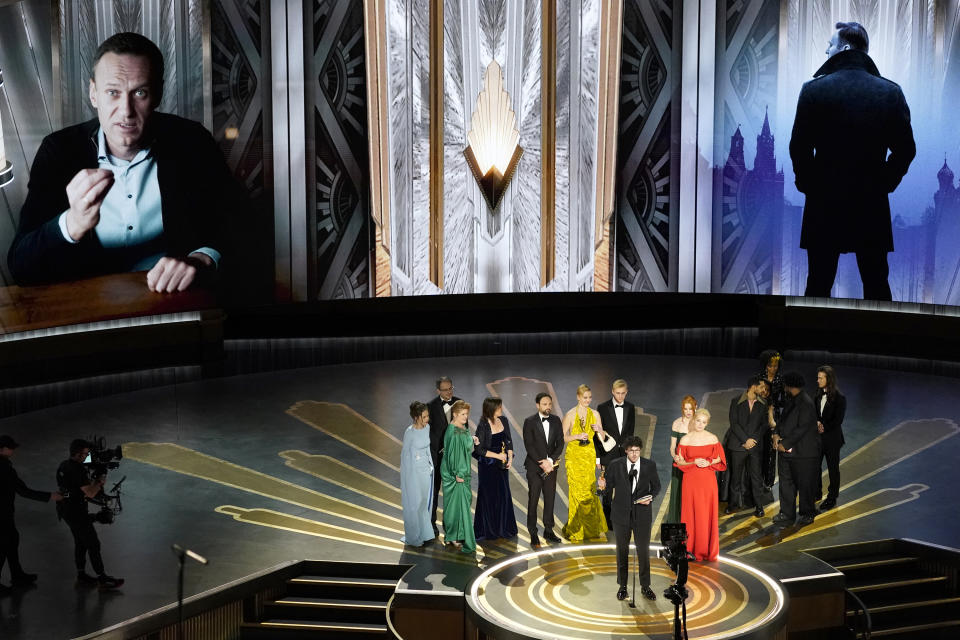 Daniel Roher and the members of the crew from "Navalny" accept the award for best documentary feature film at the Oscars on Sunday, March 12, 2023, at the Dolby Theatre in Los Angeles. (AP Photo/Chris Pizzello)