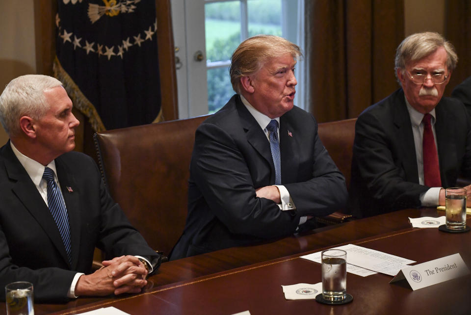 President Donald Trump, flanked by Vice President Mike Pence, left, and national security adviser John Bolton, right, speaks to the media as he meets with senior military leadership in the Cabinet Room of the White House on April 9, 2018, in Washington, D.C. (Photo: Ricky Carioti/Washington Post via Getty Images)