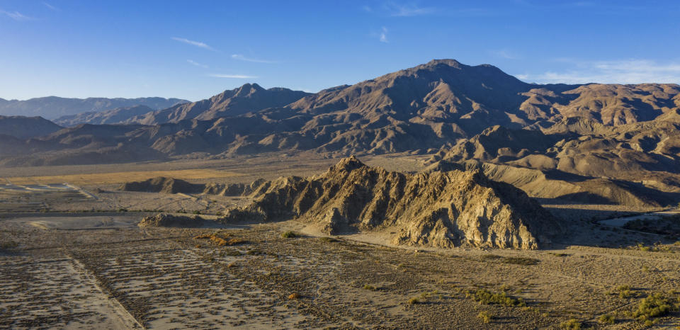 This photo provided by REM Public Relations shows the location of a proposed Coral Mountain Resort with four large human-made surf lagoons near La Quinta. Calif. seen in 2020. Hours from the California coast, surfers are hoping one of the next spots where they can catch a wave is in the hot, dry desert where summer temperatures often soar above 100 degrees. At least four large human-made surf lagoons are proposed for the region around Palm Springs, which is more commonly known for art festivals, mountain hikes and golf, and has no natural waves in sight. (Andy Potts/REM Public Relations via AP)