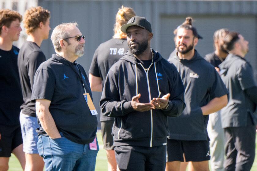 UCLA head coach Deshaun Foster talks on the sidelines during UCLA's pro day