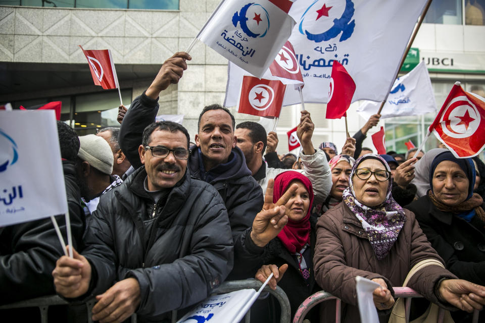 Followers of moderate islamist party Ennahdha celebrate the eighth anniversary of the democratic uprising in Tunis, Monday, Jan.14, 2019. Tunisia is marking eight years since its democratic uprising amid deepening economic troubles and simmering anger at the revolution's unfulfilled promises. (AP Photo/Hassene Dridi)