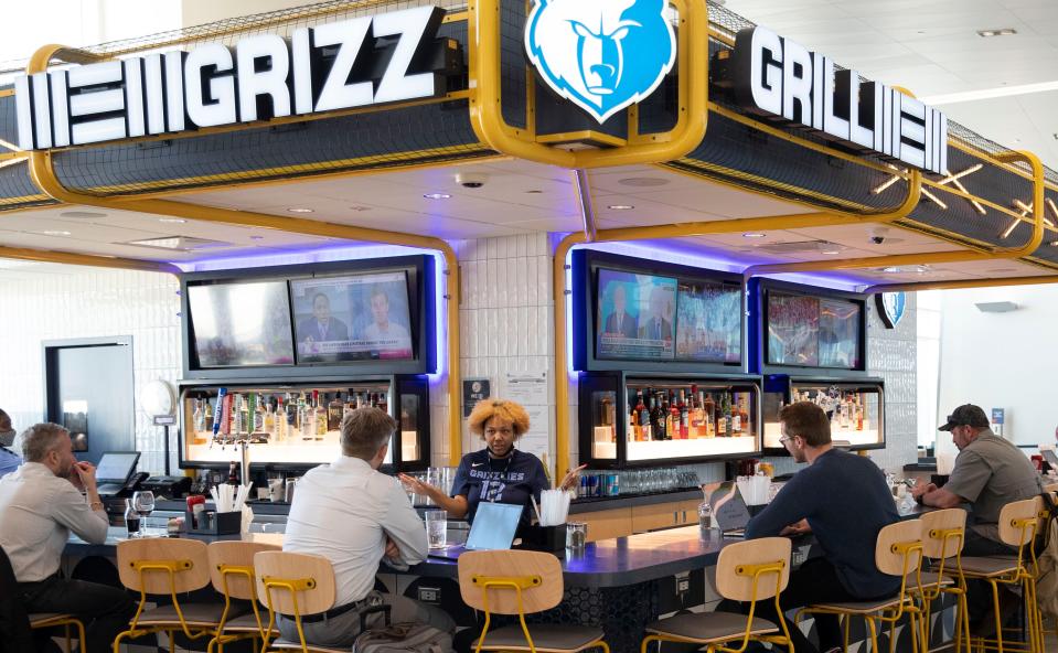 Travelers sit at the bar of Grizz Grill in Concourse B on Wednesday, March 2, 2022, at Memphis International Airport.