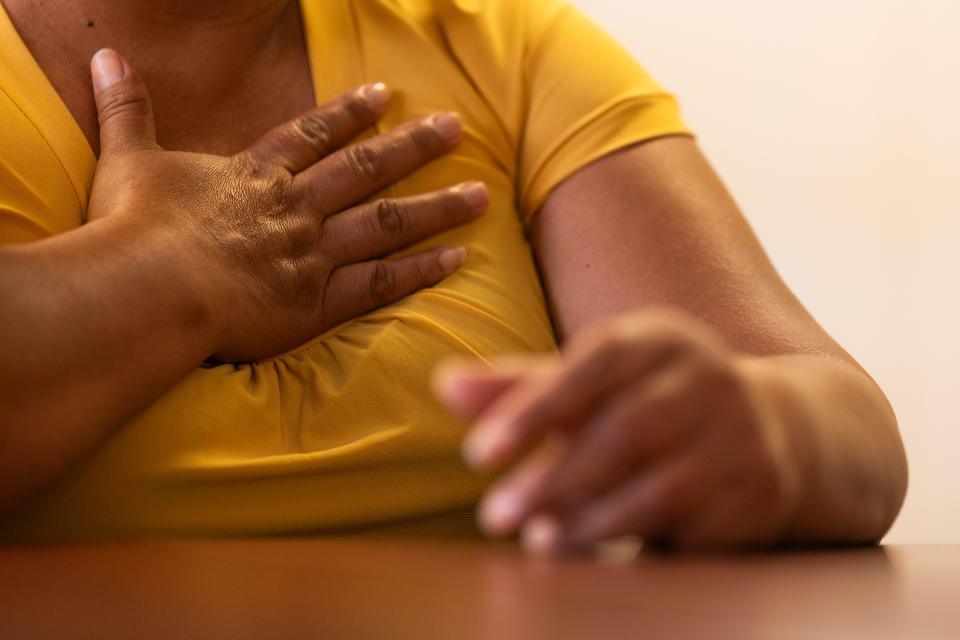 El Paso Walmart mass shooting victim Ana, who asked that her face not be photographed, speaks about the difficulties she has faced since the 2019 tragedy on Friday, Aug. 4, 2023, at Las Americas Immigration Advocacy Center in El Paso. Ana touches her chest, describing the anxiety she now feels.