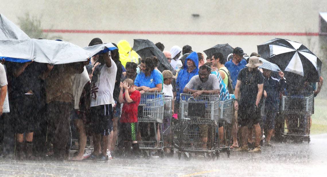 The misery continues in southeastern North Carolina continues Sunday, September 16, 2018 in Rocky Point, N.C. as customers waiting in line at the local grocery store get pelted during a deluge from Tropical Storm Florence.