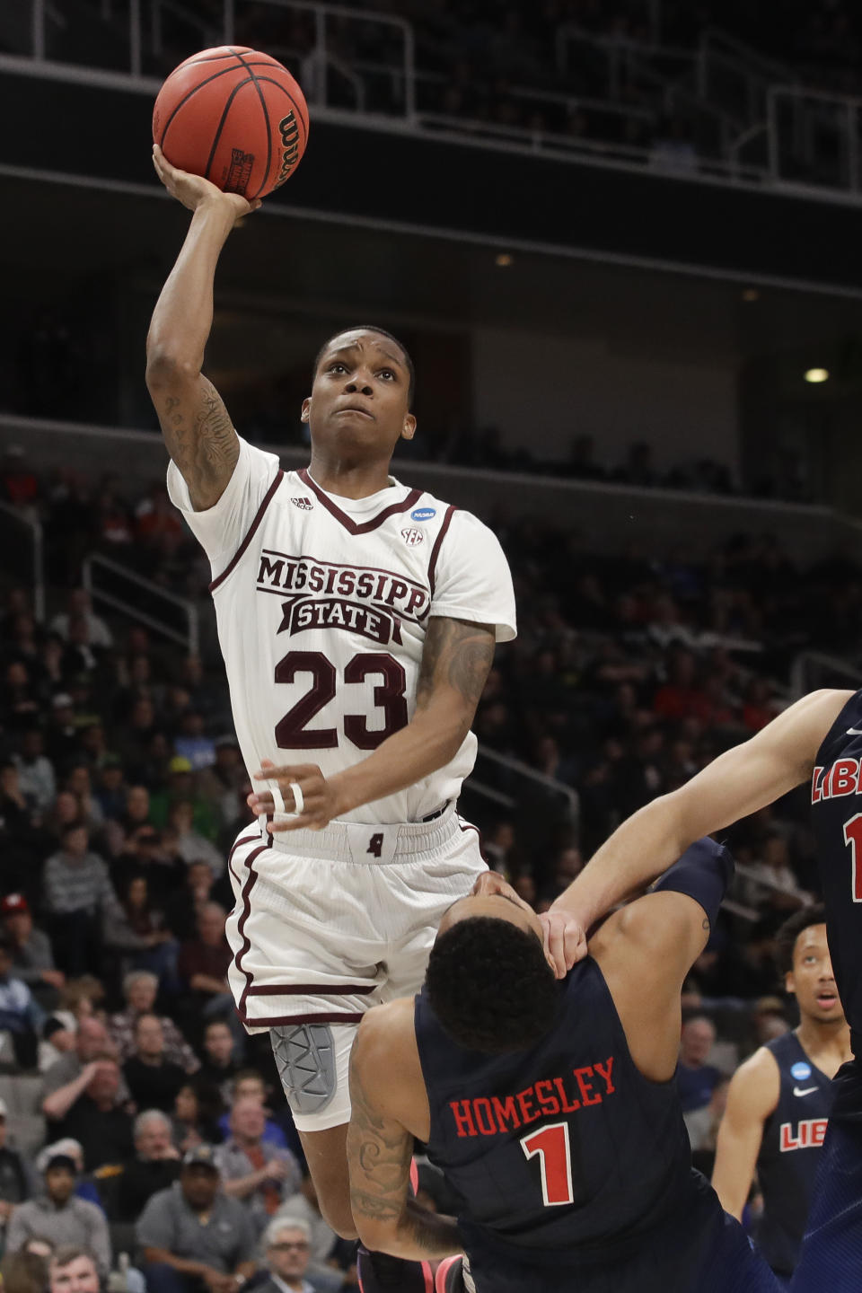 Mississippi State guard Tyson Carter shoots over Liberty guard Caleb Homesley during the second half of a first-round game in the NCAA men’s college basketball tournament Friday, March 22, 2019, in San Jose, Calif. (AP Photo/Jeff Chiu)