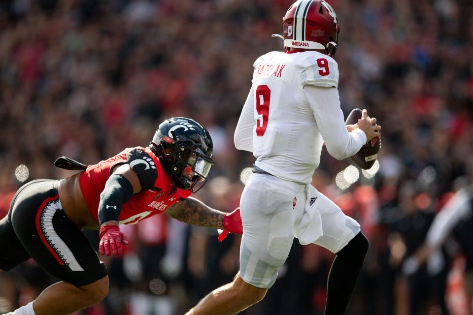 Cincinnati Bearcats linebacker Ivan Pace Jr. (0) dives toward Indiana Hoosiers quarterback Connor Bazelak (9) for a sack during the first quarter of the NCAA football game between the Cincinnati Bearcats and the Indiana Hoosiers at Nippert Stadium, Saturday, Sept. 24, 2022.