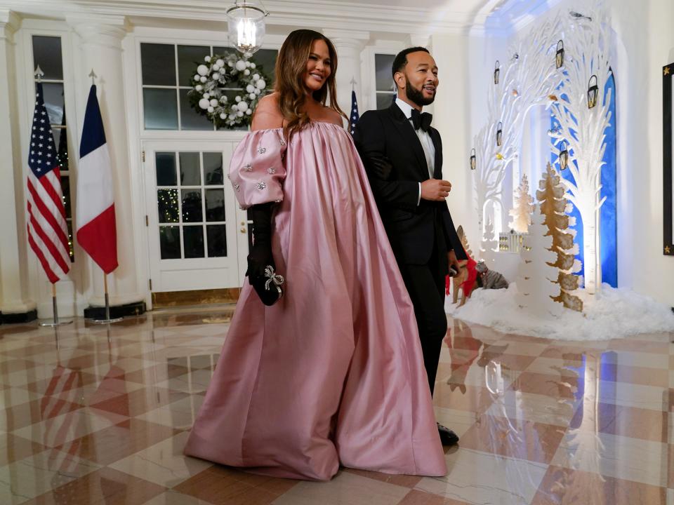 Chrissy Teigen, left, and John Legend arrive for the State Dinner with President Joe Biden and French President Emmanuel Macron at the White House in Washington, Thursday, Dec. 1, 2022.