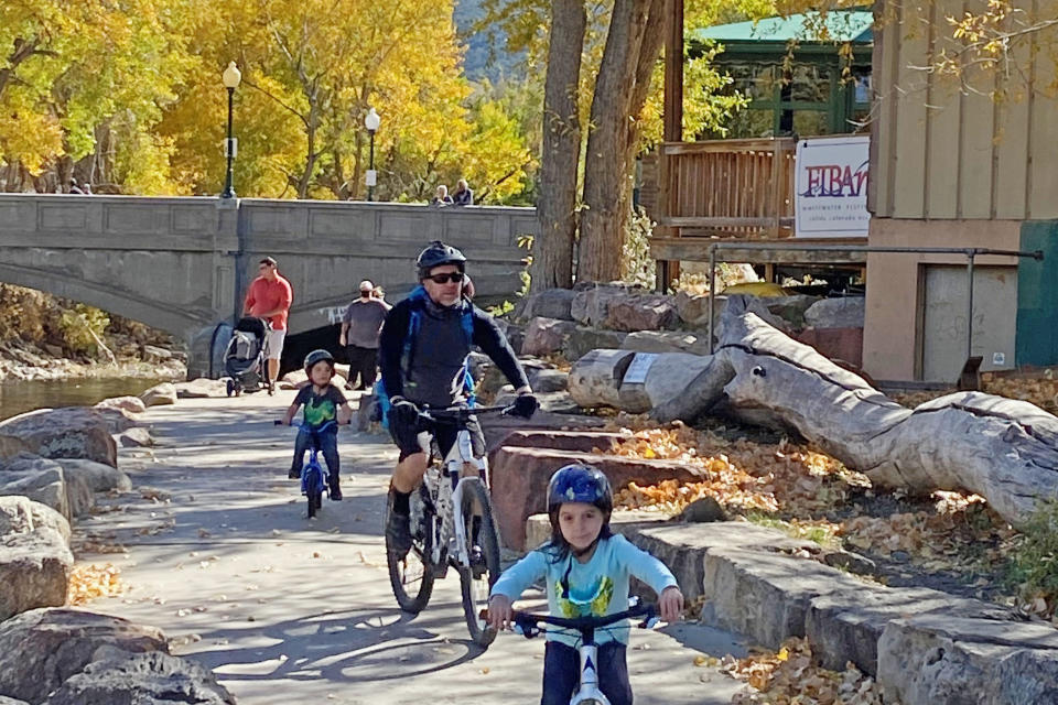 A family bikes through downtown Salida, Colo. (Vicky Collins)