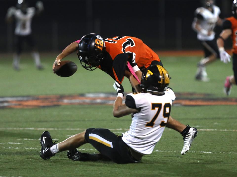 Tri-Valley's Aaron Frueh sacks New Lexington's Lukas Ratliff.