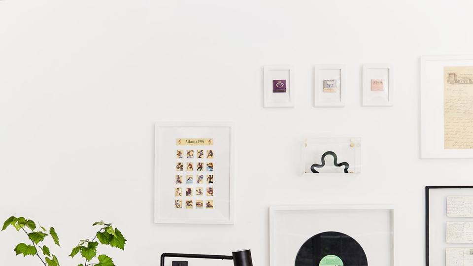 a couch with a lamp and a vase with pictures on it