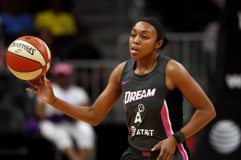 Atlanta Dream guard Renee Montgomery (21) passes the ball in the first half of a WNBA basketball game against the Chicago Sky in Atlanta, in this Tuesday, Aug. 20, 2019, file photo. (AP Photo/John Bazemore, File)