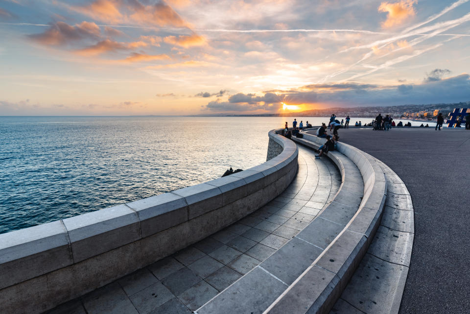 People enjoying sunset on the waterfront in Nice, Alpes-Maritimes, France