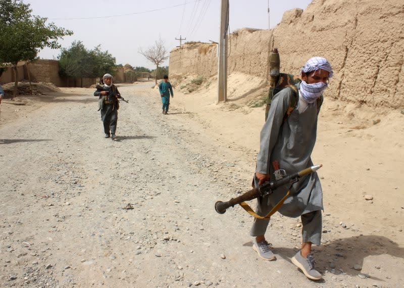 Armed Afghan militias patrol on the outskirts of Takhar province