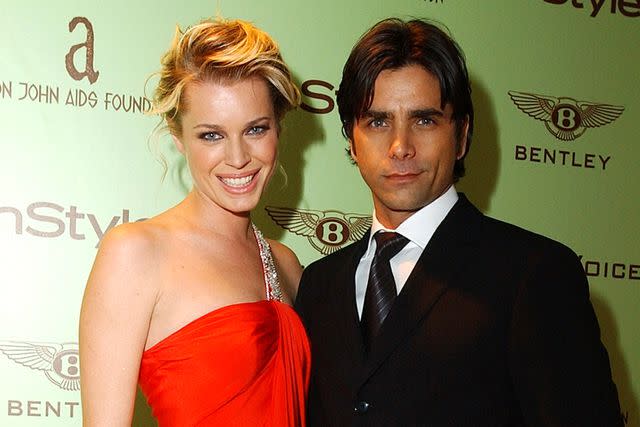 <p>Ron Wolfson/WireImage</p> (L-R) Rebecca Romijn and John Stamos.