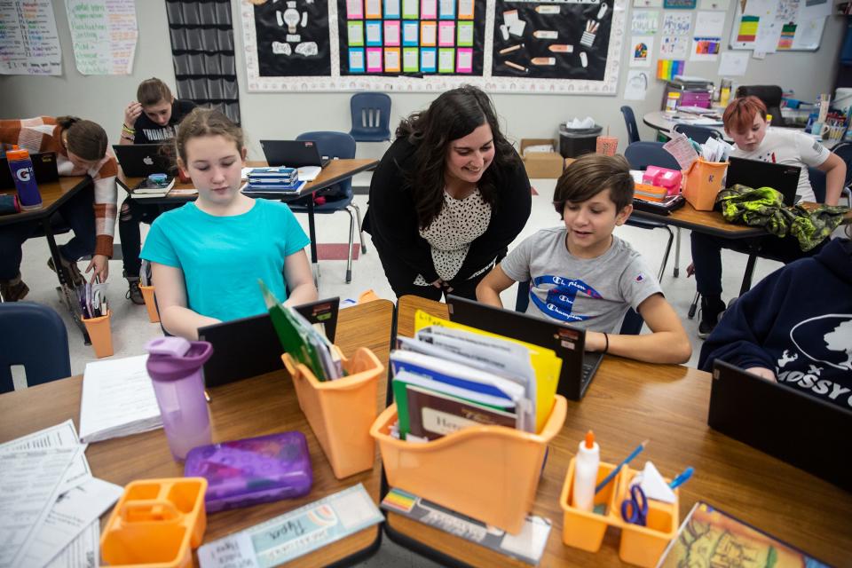 Teacher Shelby Shull helps Sixth Grader Joel Murphy with his writing, on Wednesday, Feb. 16, 2022, at Cardinal Middle School, in Eldon. 