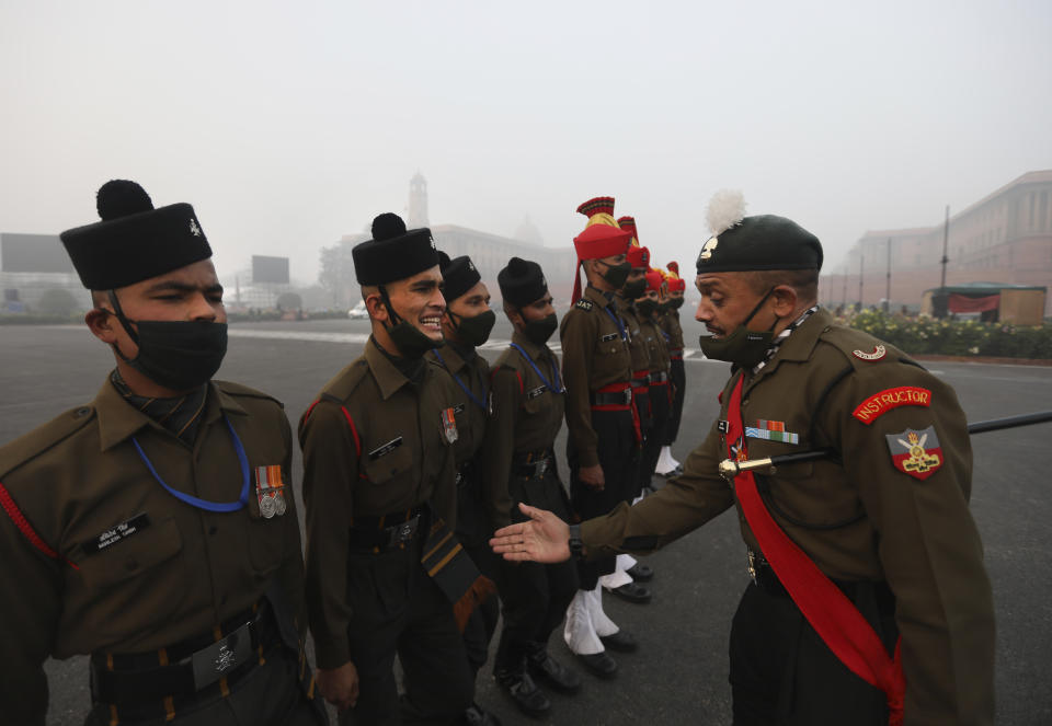 An Indian army instructor checks the marching posture of a soldier during practice for the upcoming Republic Day parade in New Delhi, India, Thursday, Jan. 21, 2021. Republic Day marks the anniversary of the adoption of the country's constitution on Jan. 26, 1950. Thousands congregate on Rajpath, a ceremonial boulevard in New Delhi, to watch a flamboyant display of the country’s military power and cultural diversity. (AP Photo/Manish Swarup)