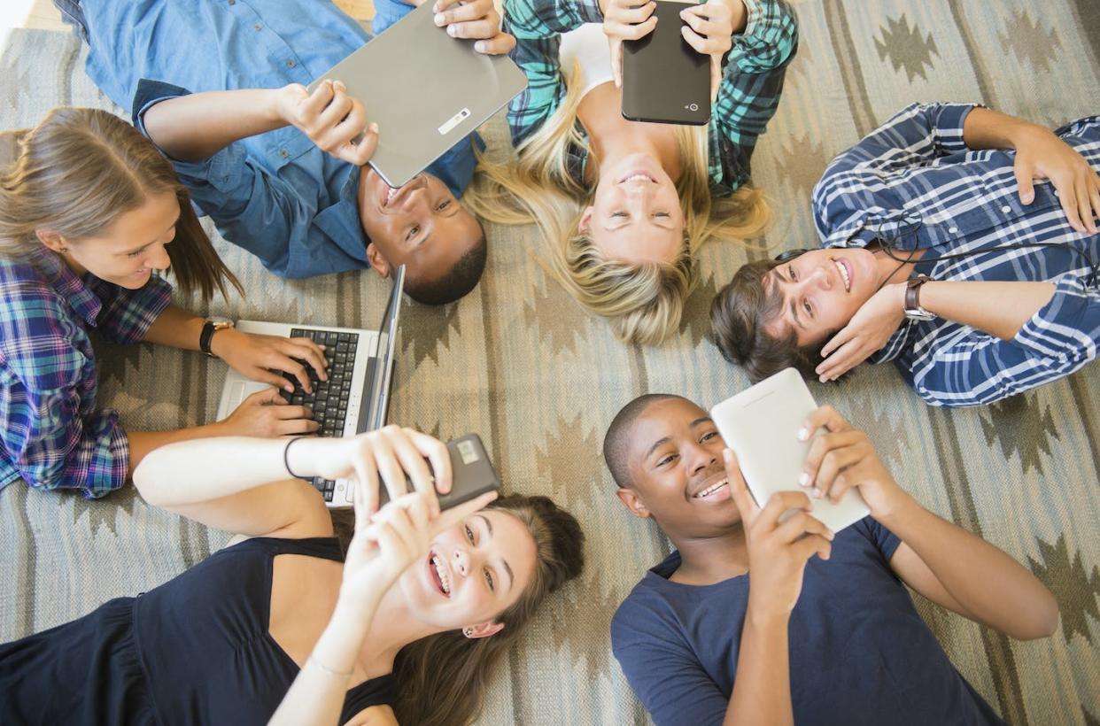 White teens and teens of color do not have identical online experiences. <a href="https://www.gettyimages.com/detail/photo/teenagers-laying-on-floor-using-technology-royalty-free-image/543195707" rel="nofollow noopener" target="_blank" data-ylk="slk:JGI/Jamie Grill/Tetra images via Getty Images;elm:context_link;itc:0;sec:content-canvas" class="link ">JGI/Jamie Grill/Tetra images via Getty Images</a>