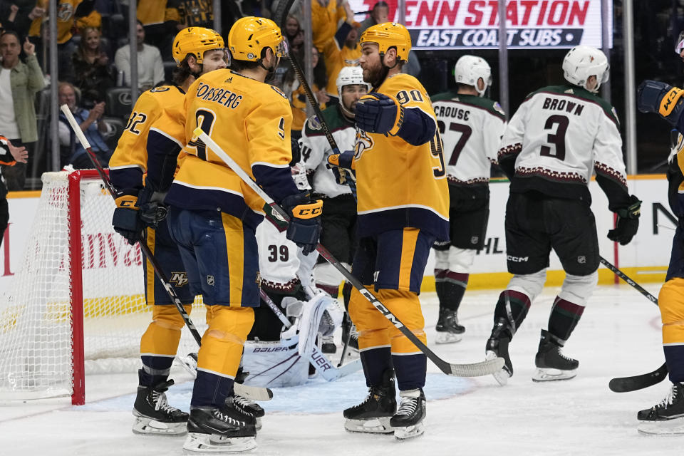 Nashville Predators center Ryan O'Reilly (90) celebrates a goal with left wing Filip Forsberg, center, and center Tommy Novak, left, during the second period of an NHL hockey game against the Arizona Coyotes, Saturday, Nov. 11, 2023, in Nashville, Tenn. (AP Photo/George Walker IV)