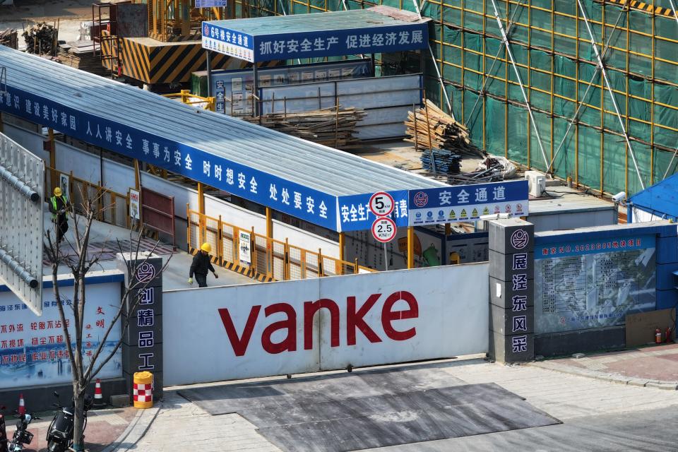 Workers inside the construction site of a residential project developed by Vanke in Nanjing in east China's Jiangsu province.