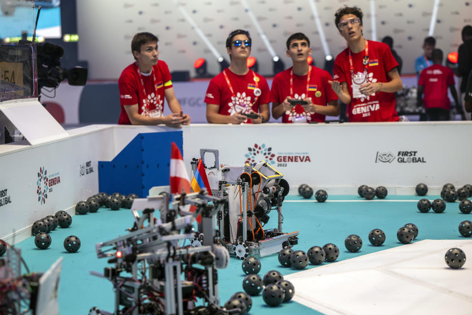 Robots from different teams compete during the 6th edition of the First Global Robotics Challenge in Geneva, Switzerland, Saturday, Oct. 15, 2022. (Martial Trezzini/Keystone via AP)