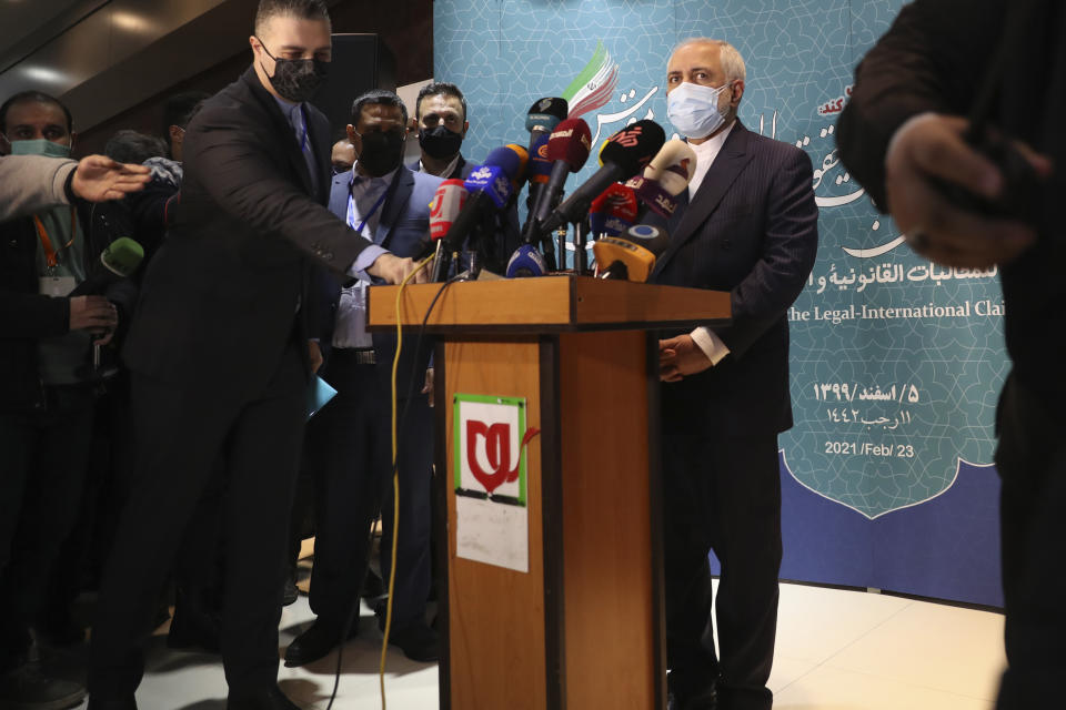 Iran's Foreign Minister Mohammad Javad Zarif prepares to speak with journalists following a conference in Tehran, Iran, Tuesday, Feb. 23, 2021. Iran's foreign minister says the country has started implementing a law passed by the parliament to curb UN inspections into its nuclear program. Zarif reiterated that Iran would no longer share surveillance footage of its nuclear facilities with the U.N. agency. (AP Photo/Vahid Salemi)