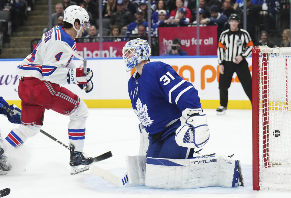 New York Rangers defenseman Braden Schneider (4) scores on Toronto Maple Leafs goaltender Martin Jones (31) during the third period of an NHL hockey game Tuesday, Dec. 19, 2023, in Toronto. (Nathan Denette/The Canadian Press via AP)