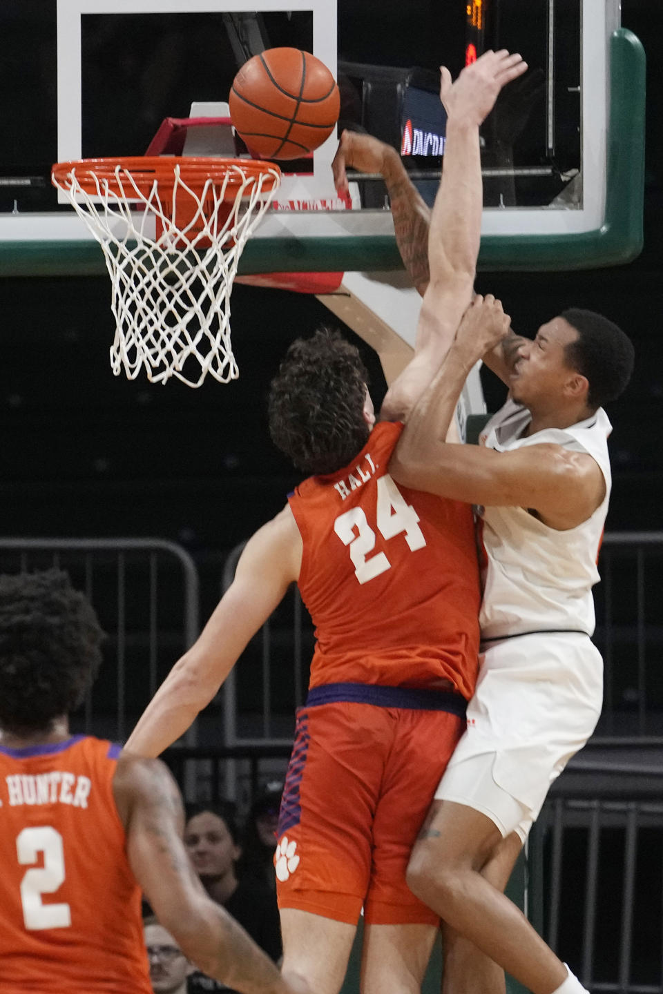 Clemson center PJ Hall (24) defends Miami guard Matthew Cleveland during the first half of an NCAA college basketball game, Wednesday, Jan. 3, 2024, in Coral Gables, Fla. (AP Photo/Marta Lavandier)