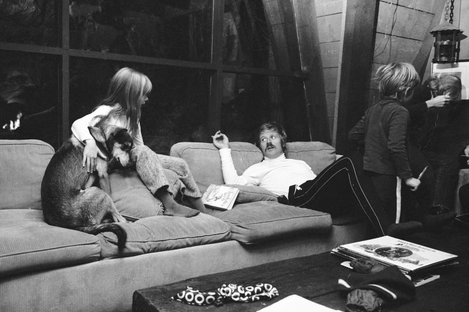 <p>Robert Redford sits on a couch with his daughter Shauna at their Utah home in 1969. His son Jamie and wife Lola Van Wagenen stand to the right. </p>