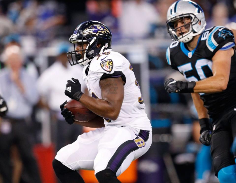 Kenneth Dixon #30 of the Baltimore Ravens runs with the ball during a preseason NFL game against the Carolina Panthers. (Photo by Joe Robbins/Getty Images)