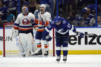 Tampa Bay Lightning left wing Alex Killorn (17) reacts as New York Islanders goaltender Semyon Varlamov (40) and defenseman Adam Pelech (3) celebrate their victory during Game 1 of an NHL hockey Stanley Cup semifinal playoff series Sunday, June 13, 2021, in Tampa, Fla. (AP Photo/Chris O'Meara)