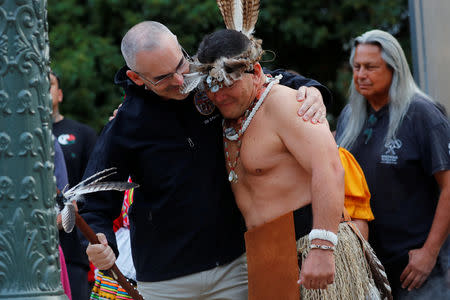 Los Angeles City Council member Mitch O'Farrell (L) hugs Kevin Nunez of the Gabrielino-Tongva tribe during a sunrise ceremony after Los Angeles City Council voted to establish the second Monday in October as "Indigenous People's Day", replacing Columbus Day, in Los Angeles, California, U.S., October 8, 2018. REUTERS/Mike Blake