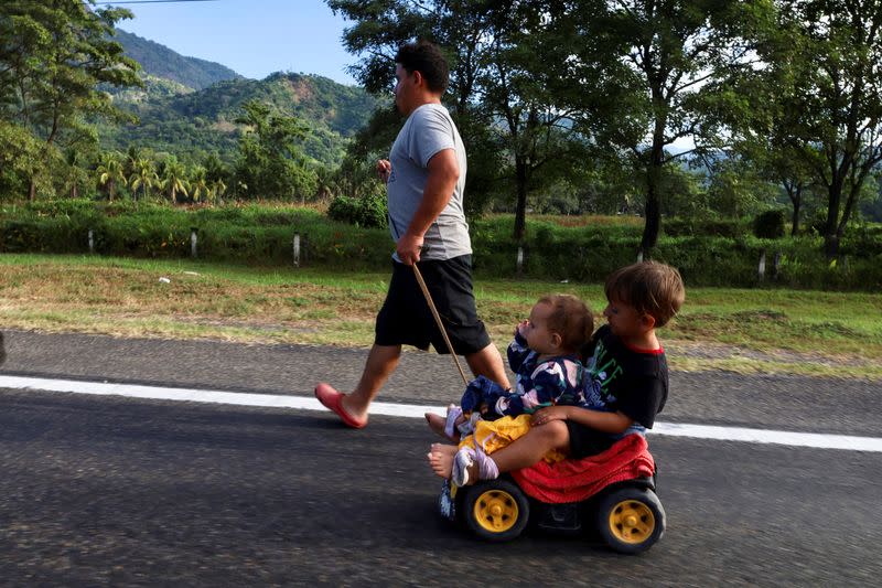 Migrants walk in a caravan to reach the U.S. border through Mexico, in Escuintla