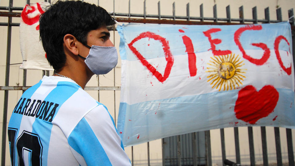 An Argentinian man, pictured here wearing a Maradona t-shirt in tribute.