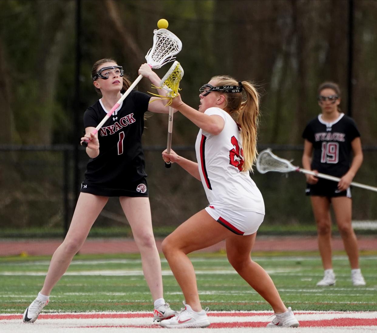 Nyack V Rye Girls Lacrosse
Nyack's Casey Cummings (1) and Rye's Lilly Whaling (22) take a draw in girls lacrosse action at Rye High School in Rye on Wednesday, April 10, 2024. Nyack won 13-11.