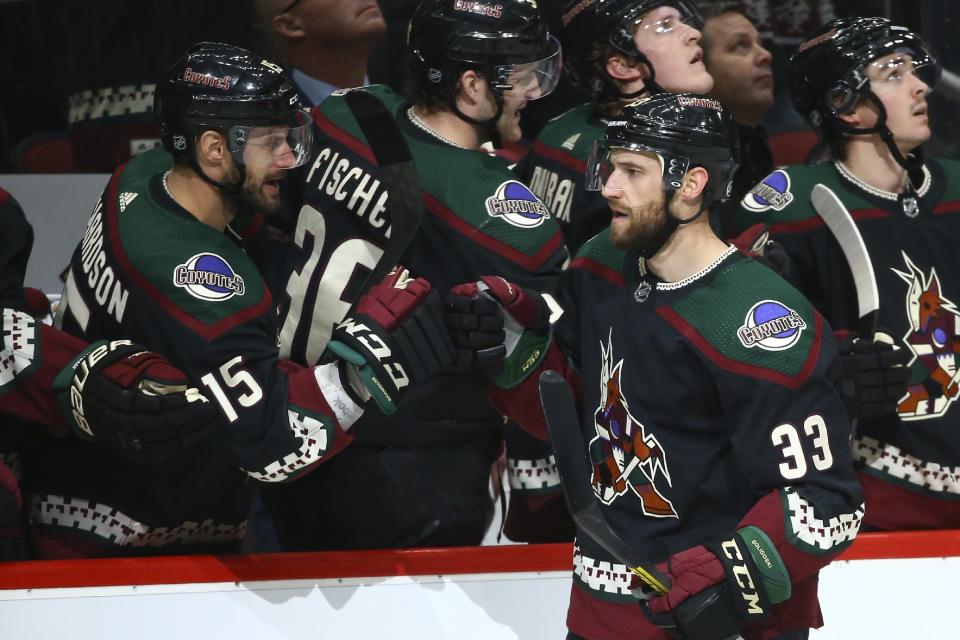 Arizona Coyotes defenseman Alex Goligoski (33) celebrates his goal against the New Jersey Devils with Coyotes' Brad Richardson (15) during the first period of an NHL hockey game, Saturday, Dec. 14, 2019 in Glendale, Ariz. (AP Photo/Ross D. Franklin)