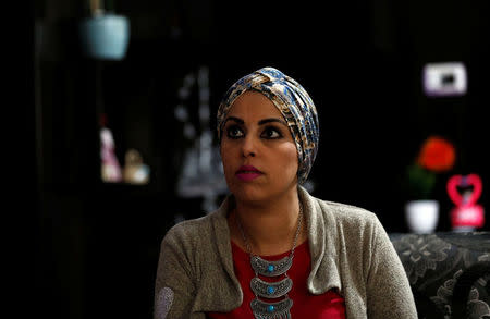 Haya Khader, a Palestinian teacher from East Jerusalem, listens during an interview with Reuters in Kfar Aqab on the outskirts of Jerusalem, near the West Bank City of Ramallah, November 7, 2017. Picture taken November 7, 2017. REUTERS/Mohamad Torokman