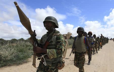 African Union Mission in Somalia (AMISOM) peacekeepers from Burundi patrol after fighting between insurgents and government soldiers erupted on the outskirts of Mogadishu in this May 22, 2012 file photo. REUTERS/Feisal Omar