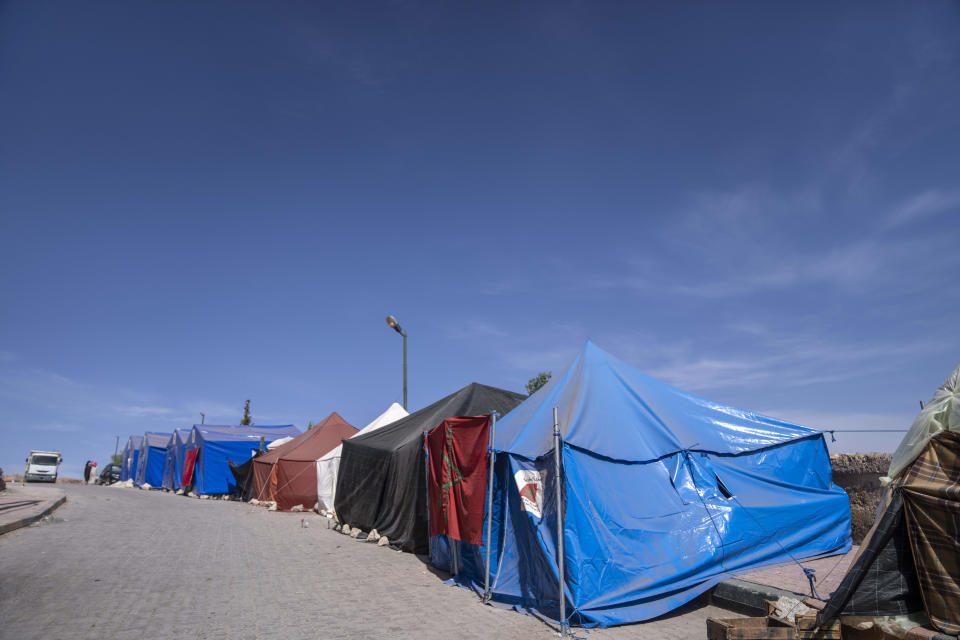 Tents for people displaced by the earthquake line up along a road leading into the town of Amizmiz, outside Marrakech, Morocco, Saturday, Oct. 7, 2023. Morocco has pledged to rebuild from a September earthquake in line with its architectural heritage. Villagers and architects agree that earthquake-safe construction is a top priority. That’s created a push for modern building materials. But the government says it wants to rebuild in line with Morocco’s cultural and architectural heritage. (AP Photo/Mosa'ab Elshamy)