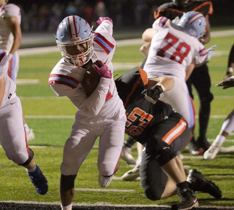 Alliance's Ravhan Hawkins scores after getting by Marlington's Landon Kensinger, right, Friday, Oct. 20, 2023.