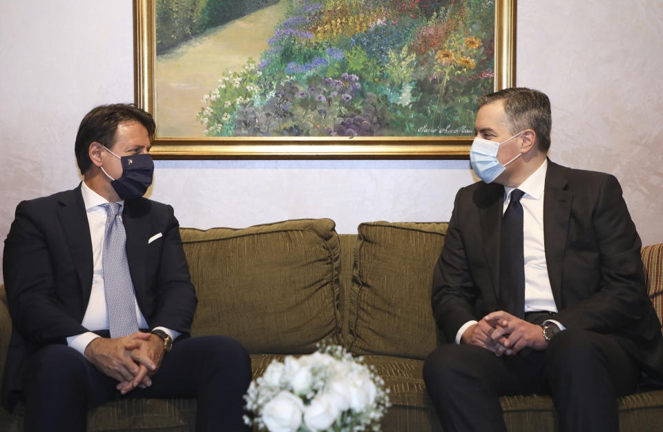 In this photo released by Lebanon's official government photographer Dalati Nohra, Lebanese Prime Minister-designate Mustapha Adib, right, meets with Italian Prime Minister Giuseppe Conte, in Beirut, Lebanon, Tuesday, Sept. 8, 2020. Conte said Tuesday his country will support Lebanon's economic and social growth, expressing hopes that a new government is formed quickly — one that would start the reconstruction process in the wake of last month's Beirut explosion and implement badly needed reforms. (Dalati Nohra via AP)