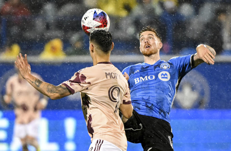 CF Montreal's Joel Waterman, right, challenges Portland Timbers' Felipe Mora during second-half MLS soccer match action in the rain in Montreal, Saturday, Oct. 7, 2023. (Graham Hughes/The Canadian Press via AP)