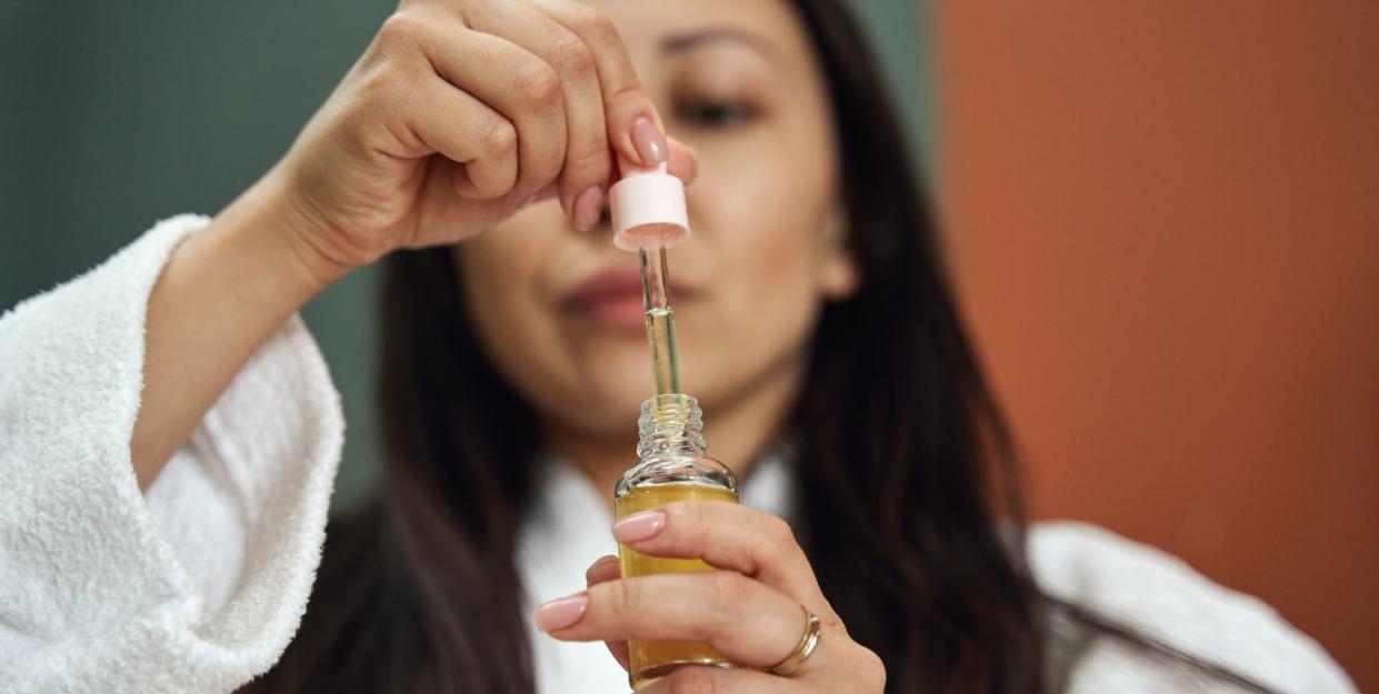 closeup shot of hands with face serum