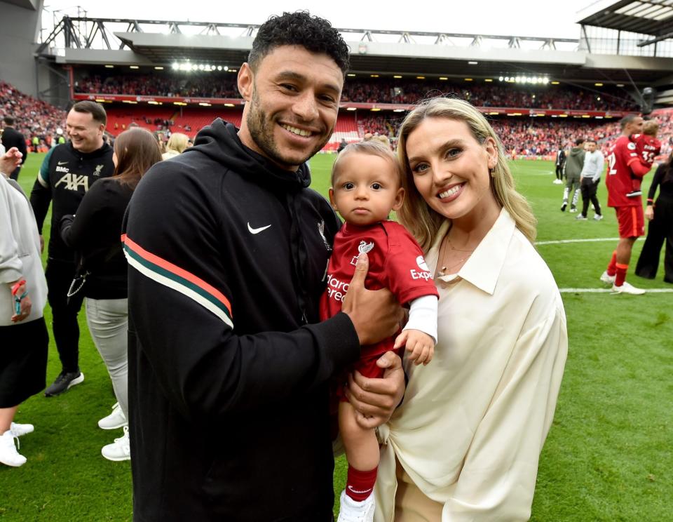 LIVERPOOL, ENGLAND - MAY 22: (THE SUN OUT, THE SUN ON SUNDAY OUT) Alex Oxlade-Chamberlain of Liverpool posing for a photograph with Perrie Edwards and their baby boy at the end of the Premier League match between Liverpool and Wolverhampton Wanderers at Anfield on May 22, 2022 in Liverpool, England. (Photo by Andrew Powell/Liverpool FC via Getty Images)